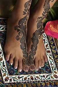 Asia Images Group - woman's feet painted with henna