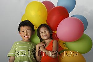 Asia Images Group - Boy and girl holding balloons.