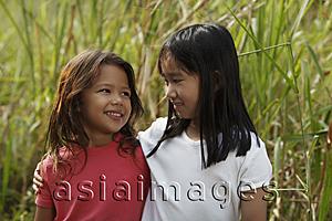 Asia Images Group - Two girls looking at each other.