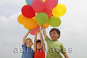 Asia Images Group - Three children holding balloons.