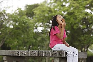 Asia Images Group - Young girl eating ice cream.