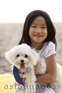 Asia Images Group - Young girl hugging dog.