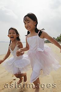 Asia Images Group - Two girls running together.