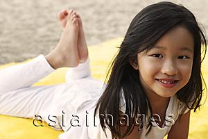 Asia Images Group - Young girl laying on stomach.