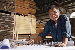 Asia Images Group - Mature man working in wood shop.