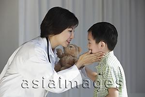 Asia Images Group - Doctor comforting young boy