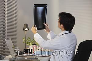 Asia Images Group - Doctor looking at X Ray