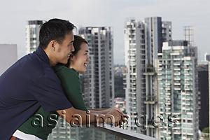 Asia Images Group - Young couple hugging and looking at view