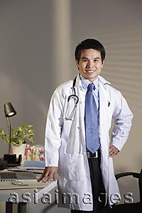 Asia Images Group - Doctor standing in office smiling