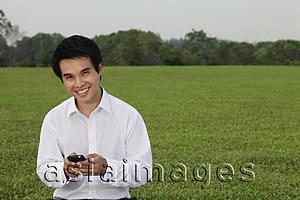 Asia Images Group - man in white shirt texting on phone and smiling