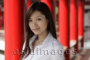Asia Images Group - Head shot of Chinese woman in front of red pillars