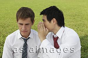 Asia Images Group - Business man whispering to another man