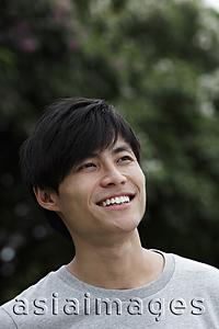 Asia Images Group - Head shot of Chinese man smiling and looking up