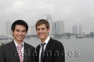 Asia Images Group - Chinese and Caucasian man standing in front of city skyline