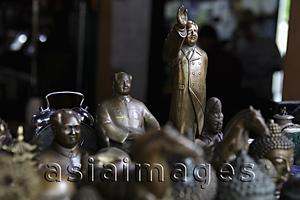 Asia Images Group - A display of bronze Chairmen Mao statues and other collectibles