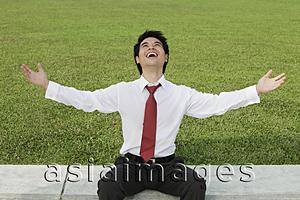 Asia Images Group - Man in shirt and tie looking up at sky and laughing