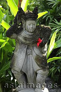 Asia Images Group - stone Hindu statue with red flower