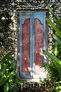 Asia Images Group - carved wooden doors in stone wall