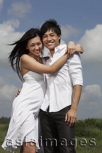 Asia Images Group - Young couple hugging each other and smiling outside