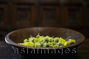 Asia Images Group - Yellow chrysanthemum flowers in wooden bowl