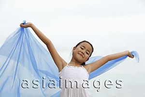 Asia Images Group - young girl holding blue cloth smiling