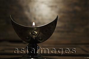 Asia Images Group - Silver cresent candle holder with lit candle