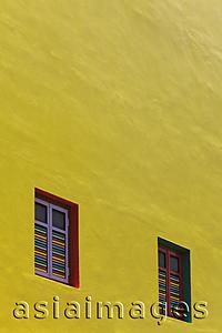 Asia Images Group - Yellow painted wall with bright colored windows