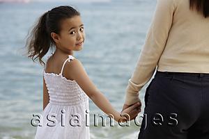 Asia Images Group - mother and daughter holding hands, daughter looking back