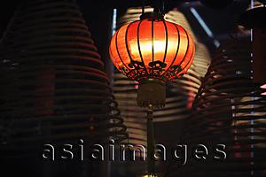 Asia Images Group - Red lantern with incense coils in foreground