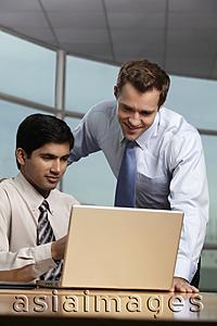 Asia Images Group - Caucasian man looking at laptop with Indian man