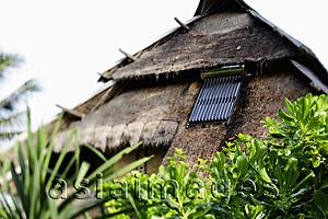 Asia Images Group - solar panel on thatched hut