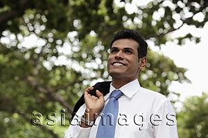Asia Images Group - Indian man with coat over his shoulder smiling