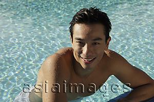 Asia Images Group - Young man in swimming pool smiling
