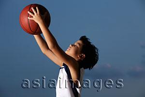 Asia Images Group - Young boy catching basket ball