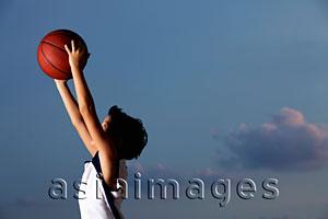 Asia Images Group - profile shot of young boy catching basketball