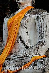 Asia Images Group - Cropped shot of stone Buddha wearing yellow robe, Thailand