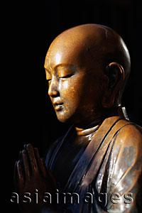 Asia Images Group - Profile of bronze Buddhist statue praying. Asakusa Kannon Temple,