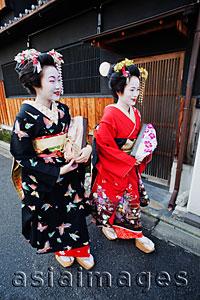 Asia Images Group - Geishas walking down the street in traditional Japanese clothing