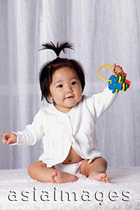 Asia Images Group - Young baby holding toy keys