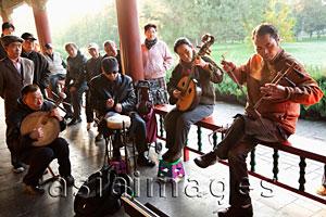 Asia Images Group - China,Beijing,Temple of Heaven Park, Group Playing Traditional Chinese Stringed Instruments