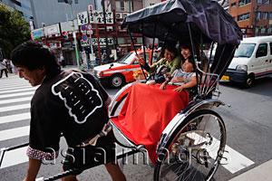 Asia Images Group - Family taking a Rickshaw ride. Japan,Tokyo,Asakusa,
