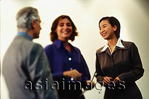 Asia Images Group - Asian female executive talking with two Caucasian executives