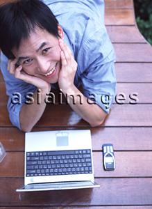 Asia Images Group - Man lying down with hands supporting head, portrait, elevated view