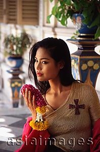 Asia Images Group - Thai woman holding flowers