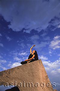 Asia Images Group - Woman doing Yoga outdoors