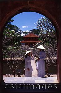 Asia Images Group - Vietnam, Hue, Tomb of Minh Mang, two young women in traditional Vietnamese dress