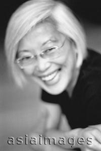 Asia Images Group - Mature woman with glasses, laughing, portrait