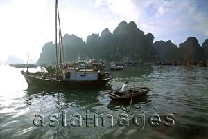 Asia Images Group - Vietnam, Halong Bay, woman rowing boat.