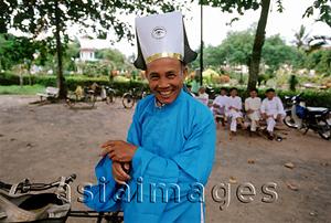 Asia Images Group - Vietnam, Tay Ninh, Cao Dai priest in blue robe.