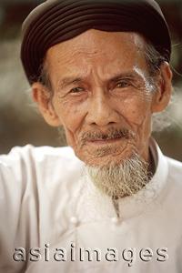 Asia Images Group - Vietnam, Tay Ninh, Cao Dai elderly worshipper (close up).